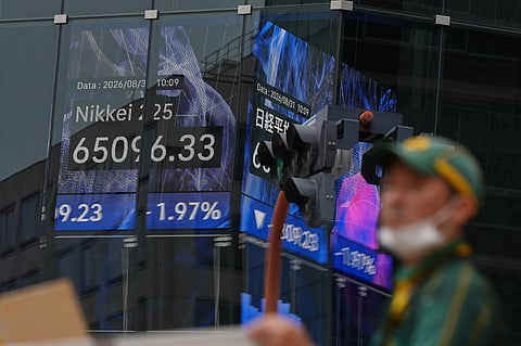 A person walks in front of an electronic stock board showing Japan's Nikkei index at a securities firm Monday, Aug. 31, 2026, in Tokyo.