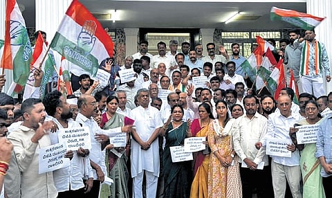 Congress members led by KPCC chief BK Hariprasad protest against the registration of FIR against LoP in Lok Sabha Rahul Gandhi, in Bengaluru on Monday | Express