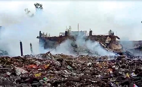 Smoke erupts from charred remains after an explosion in a firecracker factory in the Pipri area, Kaushambi, on Monday, Aug. 31, 2026.