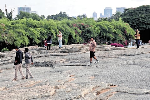 Joggers enjoy a serene morning at Lalbagh Rock. The proposed Tunnel Road project will run below the rock touching the edges of Lalbagh lake and waterfall | Kevin Nashon