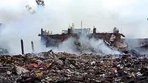 Smoke erupts from charred remains after an explosion in a firecracker factory in the Pipri area, Kaushambi, on Monday, Aug. 31, 2026.