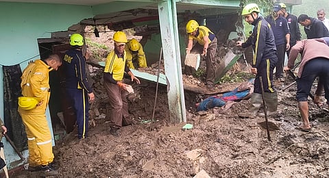 Officials carry out an evacuation at a house damaged by floods in Uttarakhand on Tuesday, Sept. 1, 2026.