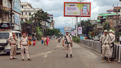 Manipur Police personnel stand guard as protesters attempt to block vehicular movement during a 24-hour general strike called by the Campaign for Just and Fair Delimitation (JFD), demanding the updation of the National Register of Citizens (NRC) before the Census, in Imphal on Tuesday, Sept. 1, 2026.