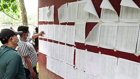 People check lists of rescued and missing persons to find information about their relatives amid ongoing rescue operations following the floods in Bidur, Tuesday, Sept. 1, 2026.