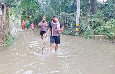 Villagers wading through floodwaters in Bishnupur under Baliapal block.