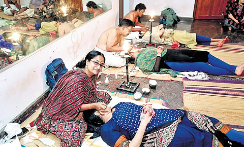 Chutti artist Abhidhanath B is doing make-up for an artist
