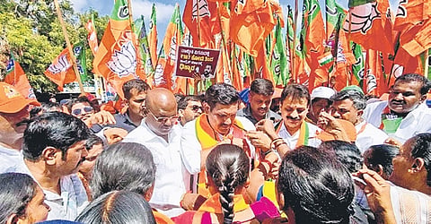 Women tie rakhis to BJP state chief BY Vijayendra on the second day of the padayatra in Maski taluk on Wednesday.