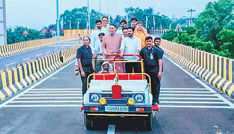 Chief Minister A Revanth Reddy, along with AIMIM president Asadduddin Owaisi, travels in an open-top vehicle on the newly inaugurated Nalgonda ‘X’ Roads steel flyover at Chanchalguda in Hyderabad on Thursday.