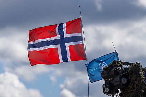 Norway's, left, and NATO's flags are seen during a military exercise 'Iron Wolf 2025-I' at the Gaiziunai Training Area, Lithuania, on May 16, 2025.