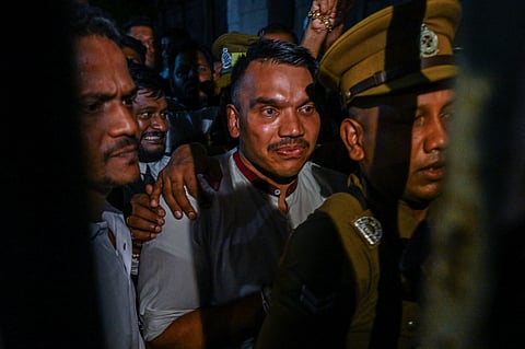 Namal Rajapaksa (C), Member of the Parliament of Sri Lanka, is being escorted by anti-graft authorities after producing before a court in Colombo on September 4, 2026 after his arrest in a corruption probe.