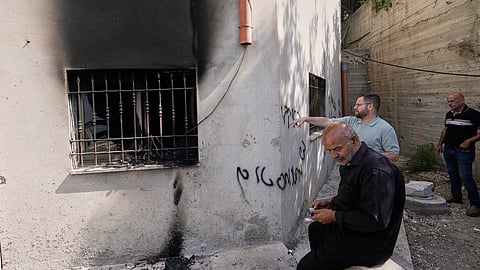 Palestinians check the damage to a mosque that, according to residents, was burned during an attack by Israeli settlers in the West Bank village of Bazariya, Tuesday, Sept. 1, 2026, as on its wall a Hebrew graffiti reads "Huckabee regards from the terrorists", referring to the US Ambassador to Israel, Mike Huckabee.