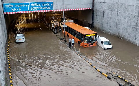 Vehicles stranded at a waterlogged tunnel near the Delhi airport following downpour in New Delhi on Friday.