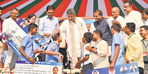 CM DK Shivakumar interacts with students during the launch of Praja Seva at Kudligi in Vijayanagara district on Saturday.