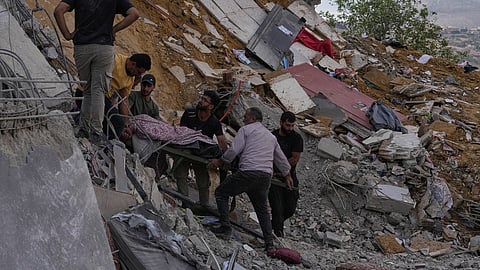 People carry a body of a person who was killed at a house that was hit by an Israeli airstrike in Arab Salim village, southern Lebanon, Sunday, Sept. 6, 2026.