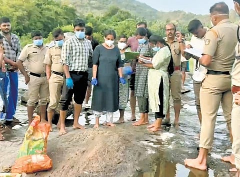 Police examining the sacks stuffed with body parts found in Bhavani river, Attappadi, on Sunday
