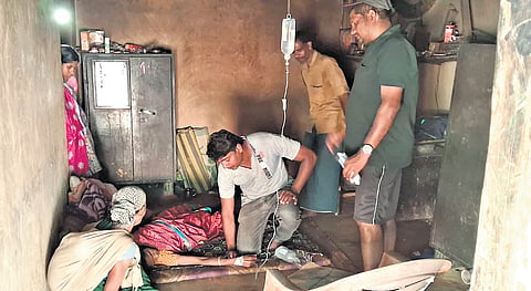 A medical team attendting to a sick patient at a settlement in Edamalakkudy