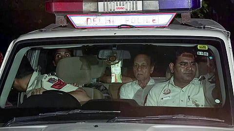 Delhi Police brings the arrested accused, Hariram, his wife Urmila, and their son Mahesh to RK Puram Police Station in connection with the Satya Niketan building collapse case, in New Delhi on Monday.