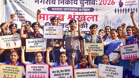 Students hold placards as they take part in a voter awareness campaign ahead of the upcoming local body elections, outside the District Collector's office, in Bikaner, Monday, Sept. 7, 2026.