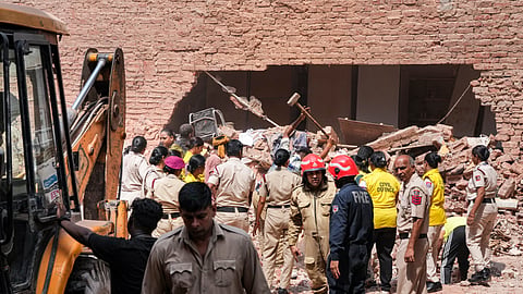Police personnel, Delhi Fire Service officials, and Civil Defence volunteers coordinate debris clearing efforts following the collapse of a multi-storey building housing a PG, at Satya Niketan, in New Delhi, Monday, Sept. 7, 2026.
