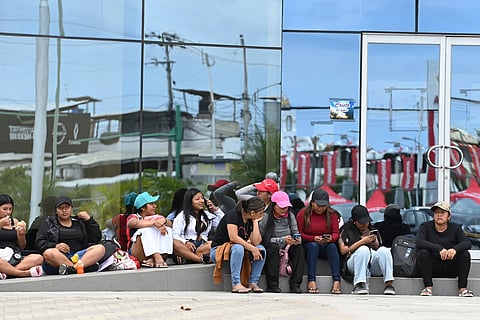 Women wait for information about the expected arrival of their relatives who were aboard the Maria Candelaria, a vessel intercepted two days prior by U.S. authorities on suspicion of alleged drug trafficking, outside a police station in Manta, Ecuador, Monday, Sept. 7, 2026.
