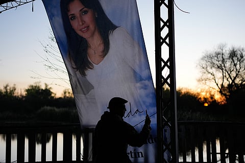 A man takes a picture at a sanctuary dedicated to Argentine singer Gilda on the 30th anniversary of her death in a bus crash, in Entre Rios