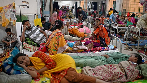 Patients receive treatment during a measles outbreak as family members sit beside them in an overcrowded hospital in Dhaka, Bangladesh, Tuesday, Sept. 8, 2026.
