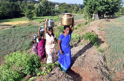Each woman fills their own pots with around 10-15 litres of water, places them on their heads and walks the 2.5 km back home