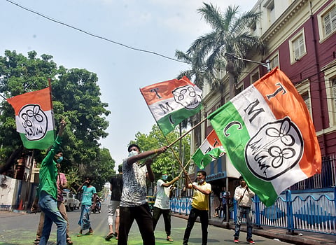 TMC supporters wave the party flag in Kolkata.