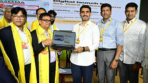 Minister for HRD Nara Lokesh with the newly elected NRI TDP Central Committee members during the oath taking ceremony in Mangalagiri on Wednesday.