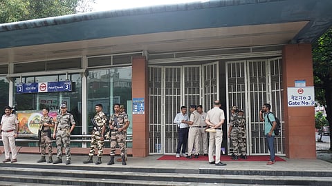 Security and Police personnel stand guard outside the gate number 3 of Patel Chowk metro station after gates were temporarily closed ahead of Cockroach Janata Party's (CJP) protest march, in New Delhi, Monday, July 20, 2026.
