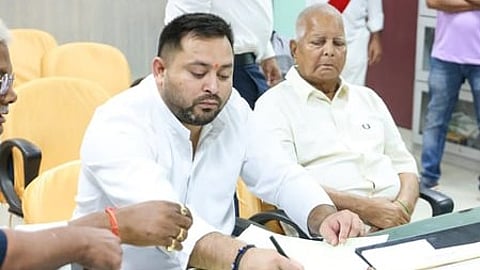 RJD supremo Lalu Prasad Yadav (R) and son Tejashwi Prasad Yadav.
