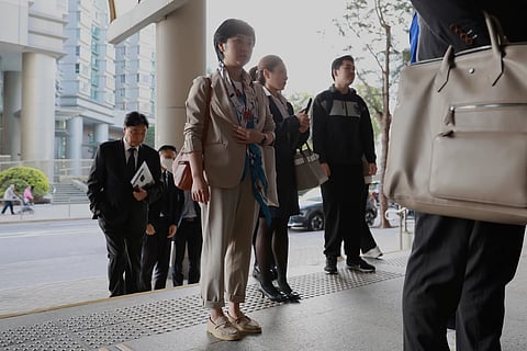 Selina Cheng, chair of the Hong Kong Journalists Association (HKJA) and a former reporter for The Wall Street Journal (WSJ), arrives at Eastern Magistrates' Court together with her legal team for her case against the paper's parent company, Dow Jones Publishing Co (Asia) Inc., in Hong Kong on Dec 18, 2025.