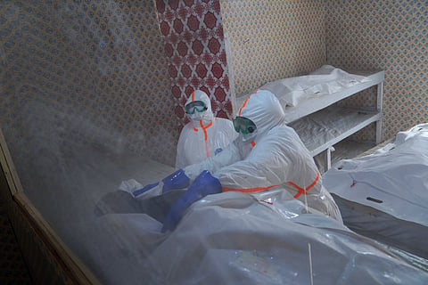 Health workers prepare to transfer the body of Abineno Justine, a 38-year-old woman who died of the Ebola virus, to a coffin ahead of her burial in Bunia, Congo, Friday, Sept. 4, 2026.