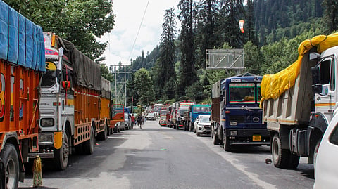 Vehicles stand stranded along the Manali-Leh National Highway in Kullu, Himachal Pradesh.