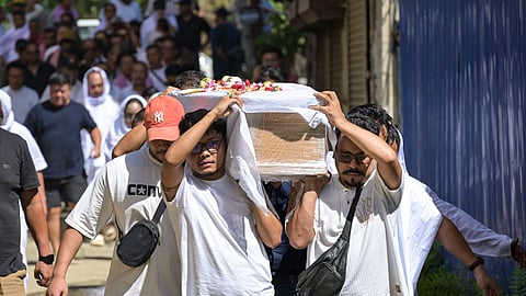 Family members and relatives carry the casket containing the mortal remains of Manipuri musician Chongtham Vikram Singh to his residence upon arrival, in Imphal, Manipur, Wednesday, Sept. 9, 2026.