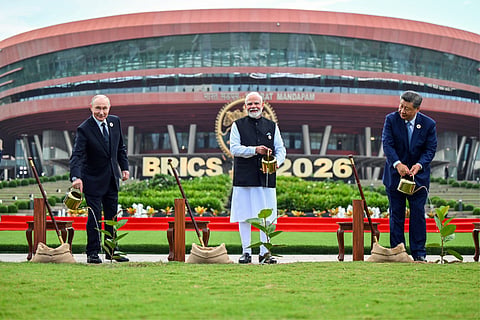 Prime Minister Narendra Modi, along with Chinese President Xi Jinping and Russian President Vladimir Putin, participates in a joint tree plantation initiative during the BRICS Summit at Bharat Mandapam, in New Delhi on Saturday.