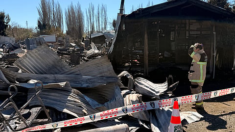Firefighters inspect the scene following a fire at a nursing home which has killed 16 people, in Pitrufquen, Araucania region, Chile on September 12, 2026.