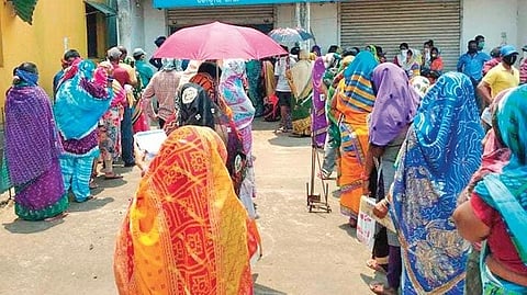 Jan Dhan account holders wait outside a bank branch.