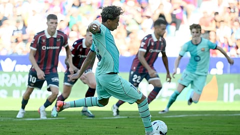 Barcelona's forward Lamine Yamal scores his team's third goal from the penalty spot during the Spanish league football match between Levante UD and FC Barcelona on September 13, 2026.