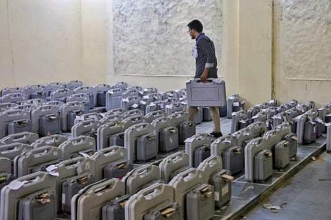A polling official places the Electronic Voting Machines (EVM) and Voter Verifiable Audit Paper Trails (VVPAT) during the counting of votes for the Rajasthan urban local body elections, at a counting centre, in Jaipur, Monday, Sept. 14, 2026.