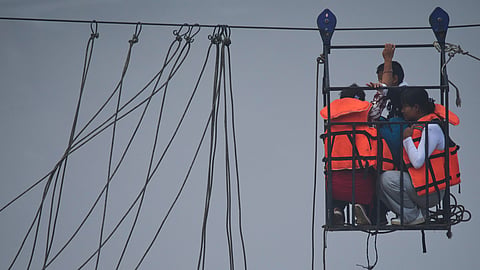 Residents commute across the Trishuli River on a newly installed zipline in the aftermath of flash floods in Devighat, Nuwakot district, Nepal, Monday, Sept. 7, 2026.