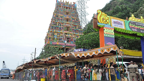 Devotees stand in a queue for darshan during Dasara festival at the entrance of Indrakeeladri hill ghat road in Vijayawada.