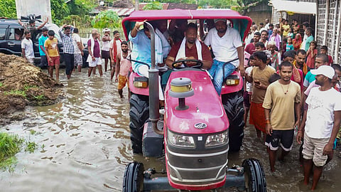 Lok Sabha MP Pappu Yadav rides a tractor during a visit to a flood-affected area, in Katihar, Bihar, Sunday, Sept. 13, 2026.