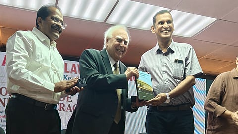 Lawyer Kaleeswaram Raj’s book ‘Constitutional Concerns: Writings on Law and Life’ being handed over to advocate Kapil Sibal at the 15th state conference
of All India Lawyers Union in Kochi.