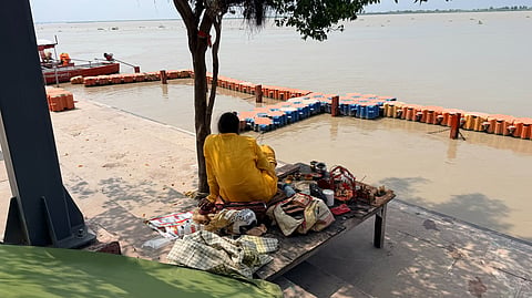 A priest awaits pilgrims at Guptar Ghat on the banks of the Saryu in Ayodhya.
