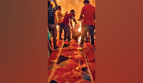 Firefighters dousing the flames at the puja pandal on Monday.
