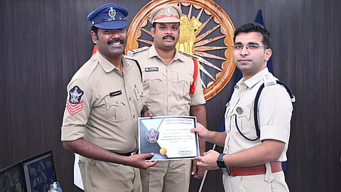 Head constable M. Chandrarao receives a cash reward and certificate from SP Tuhin Sinha in Anakapalli on Tuesday for saving an injured passenger at Tuni Railway Station.