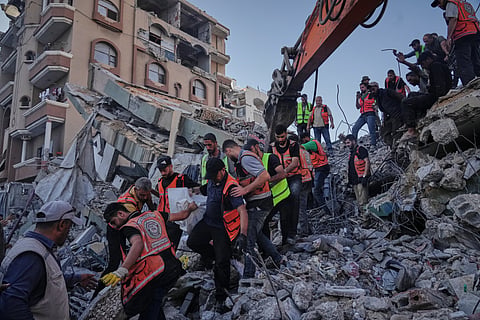 Palestinian civil defense crews carry a body from the rubble of a collapsed building that housed displaced Palestinians and was heavily damaged during the Israel-Hamas war, in Gaza City, Wednesday, Sept. 16, 2026.