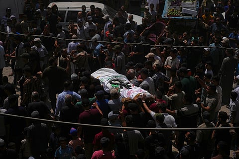 Palestinian mourners carry the body of Muhammad Yazouri, who was killed in an Israeli airstrike Thursday night, during his funeral in Khan Younis, southern Gaza Strip, Friday, Sept.11, 2026.