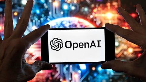 The OpenAI logo is displayed on a cell phone in front of an image generated by ChatGPT's Dall-E text-to-image model, Dec. 8, 2023, in Boston.